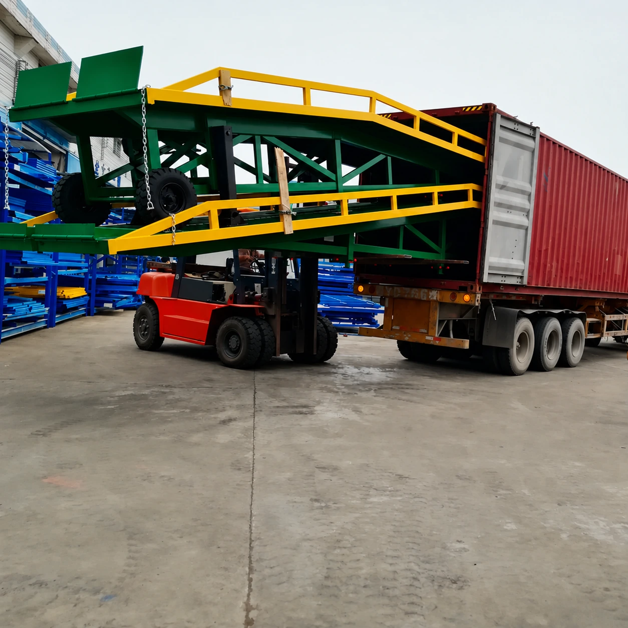 Mobile loading ramp being handled near a shipping container